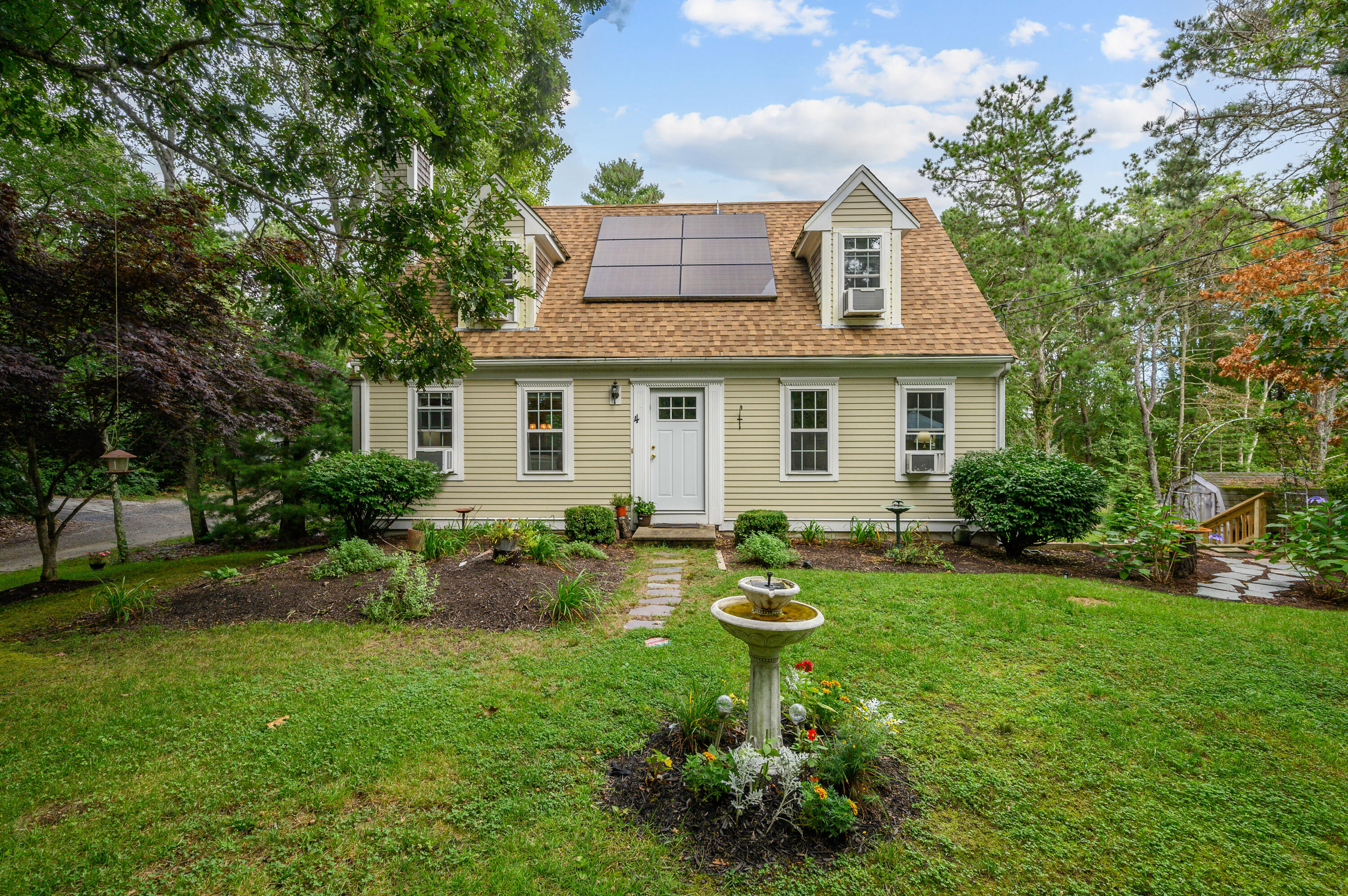 a front view of house with a garden and patio