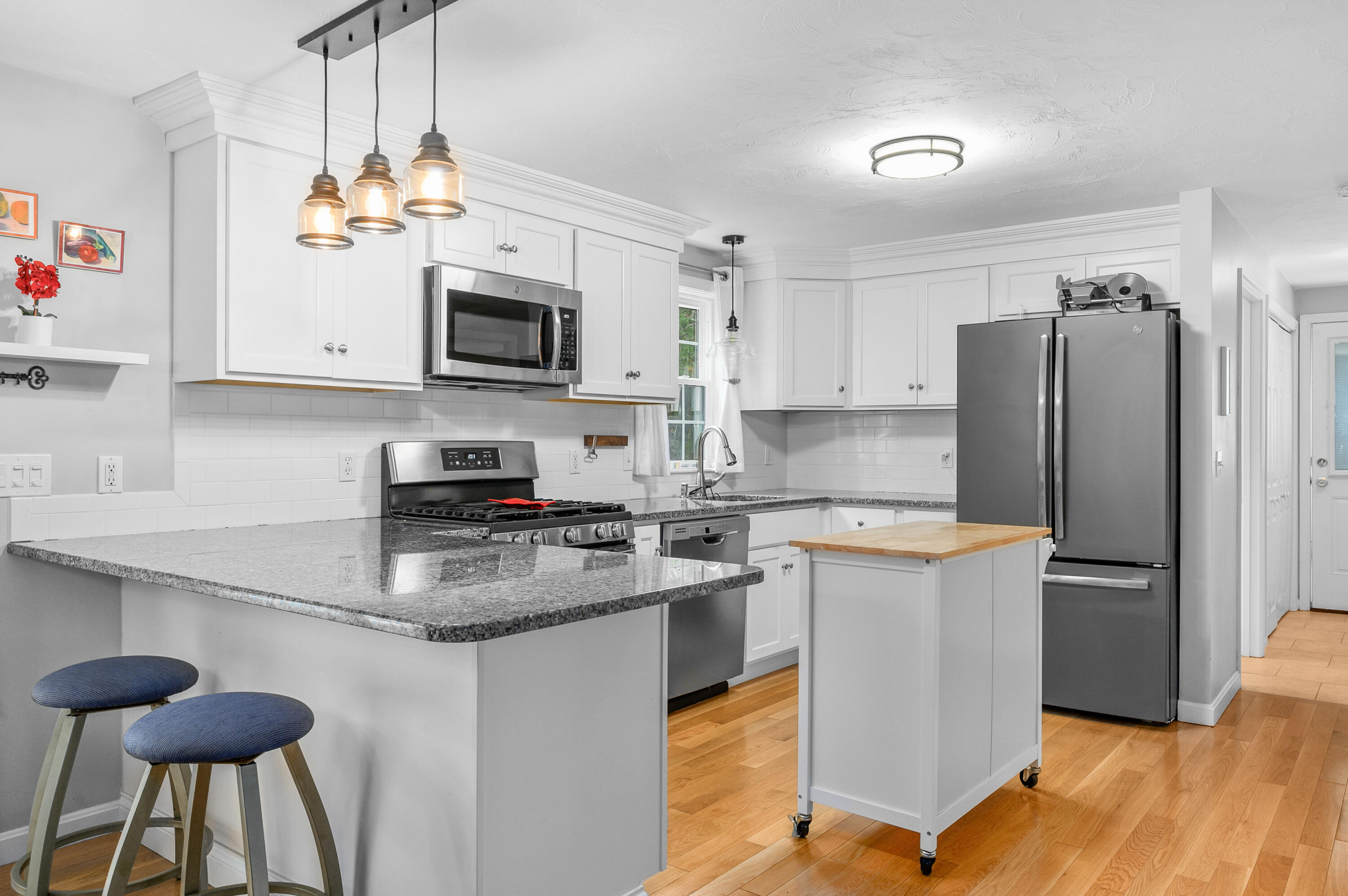 4 Santuit Lane Mashpee, MA 02649 - Photo 12 of 36 a kitchen with stainless steel appliances granite countertop a stove refrigerator sink and microwave