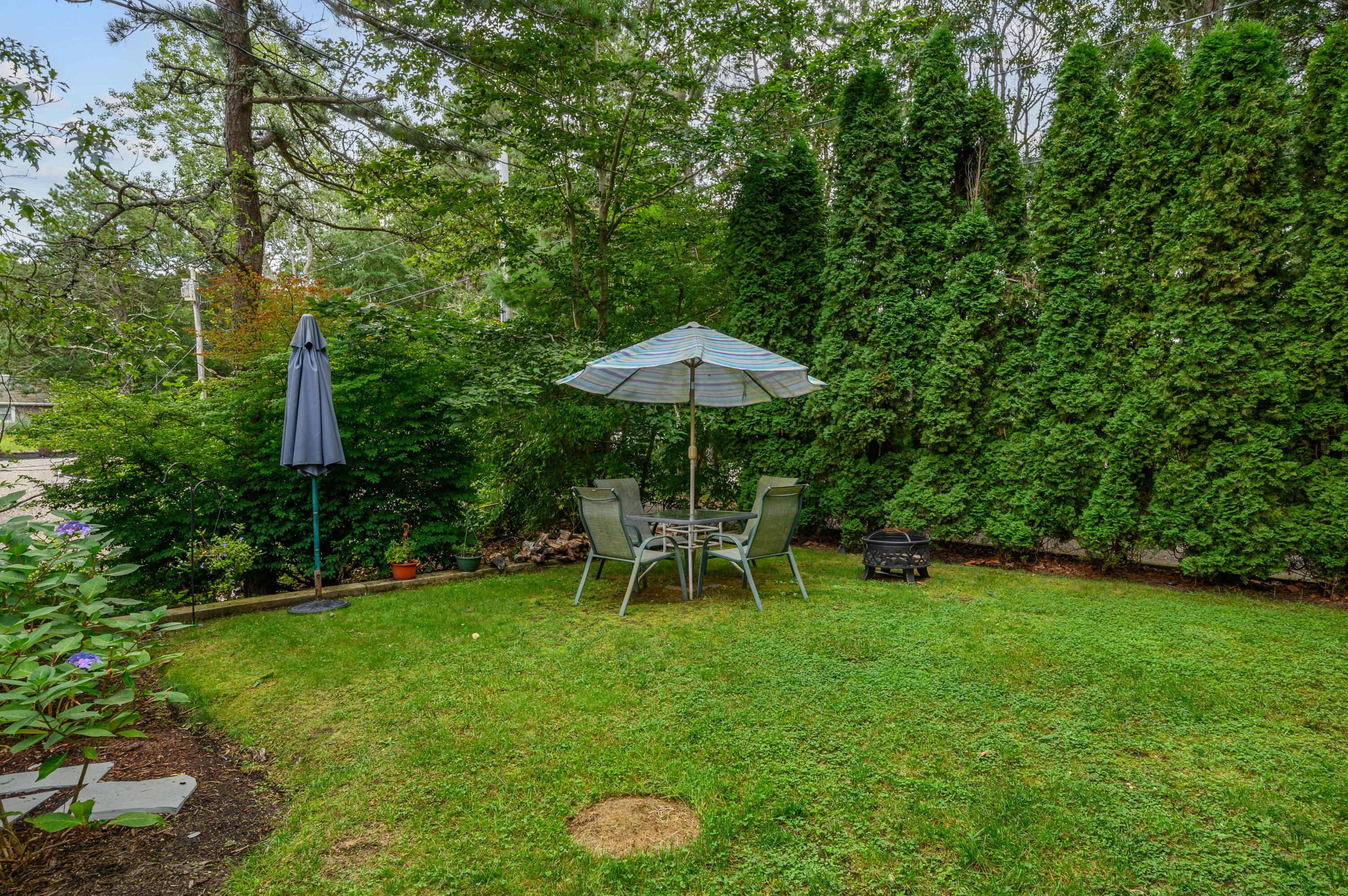 4 Santuit Lane Mashpee, MA 02649 - Photo 31 of 36 a view of a table and chairs in the garden