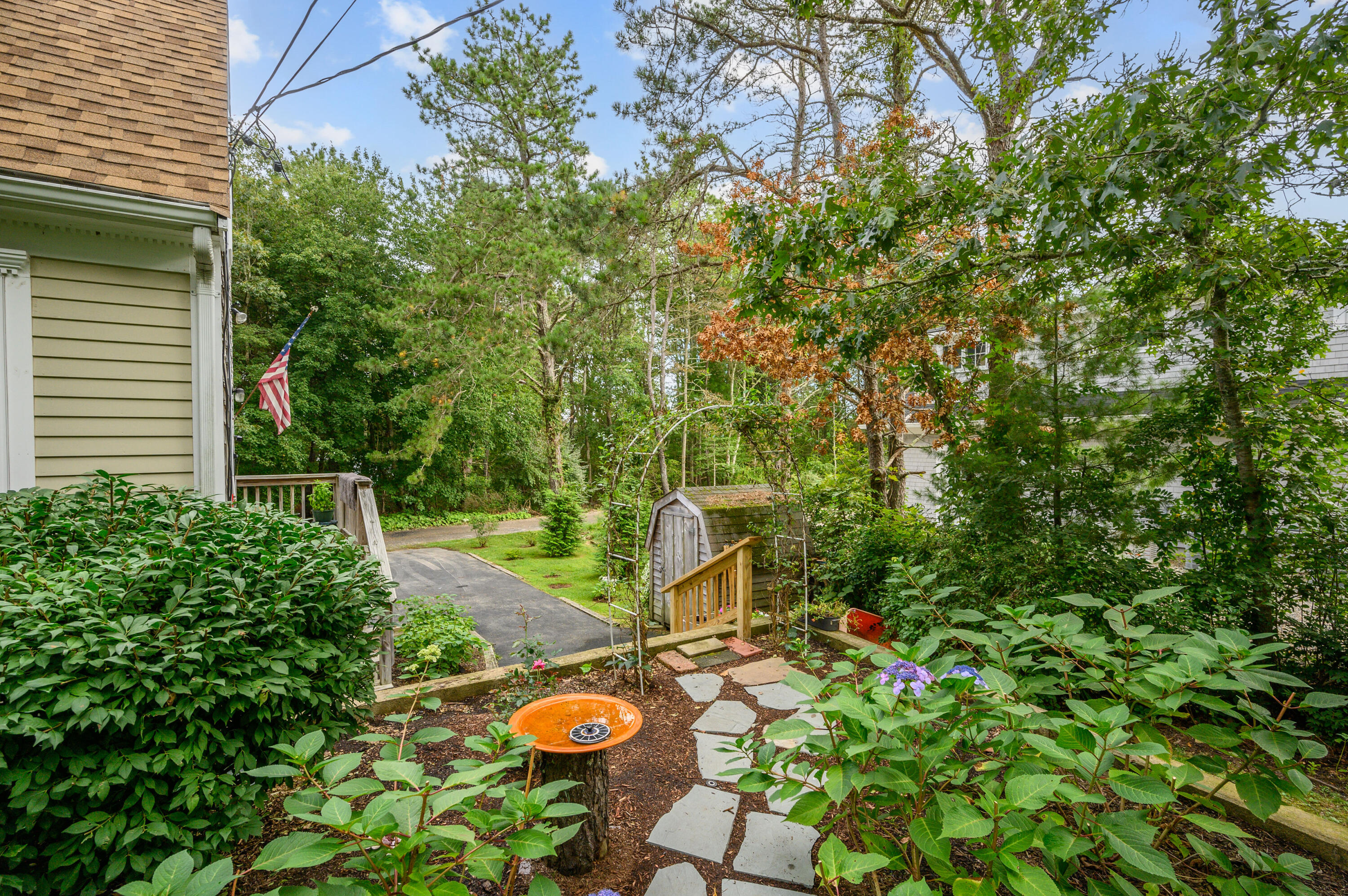 4 Santuit Lane Mashpee, MA 02649 - Photo 32 of 36 a backyard of a house with chairs and a table