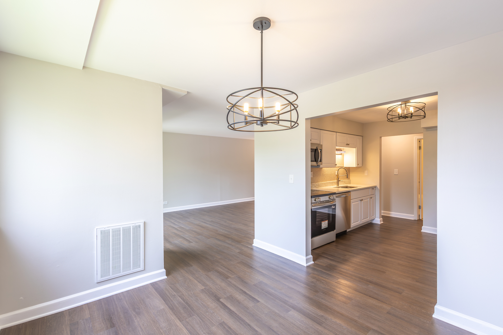 450 Raintree Court, Unit 2B Glen Ellyn, IL 60137 - Photo 7 of 28 a view of a kitchen with a sink and dishwasher a refrigerator with wooden floor