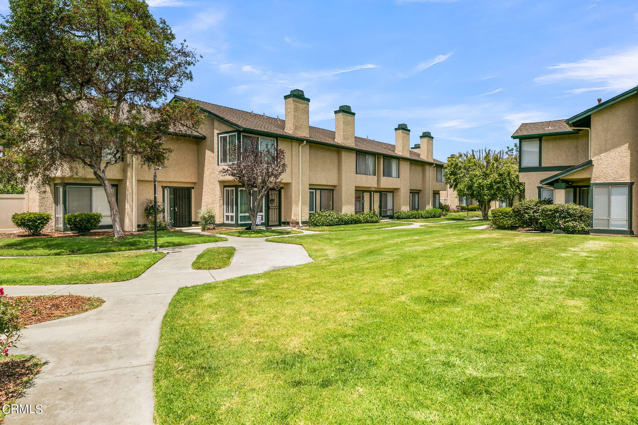 5317 Perkins Road Oxnard, CA 93033 - Photo 4 of 10 a view of a white house with a big yard and potted plants