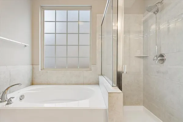 a bathroom with a bathtub and shower