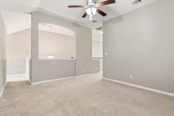 an empty room with closet and fan