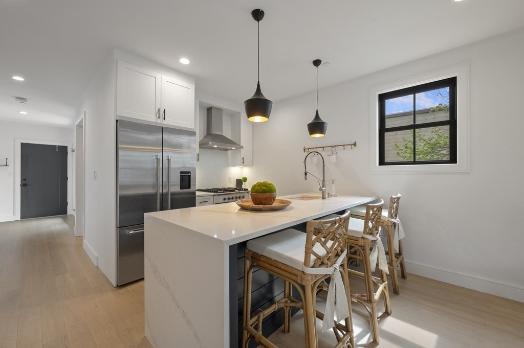 228 Webster Street, Unit 2 Boston, MA 02128 - Photo 11 of 32 a kitchen that has a table and chairs in it