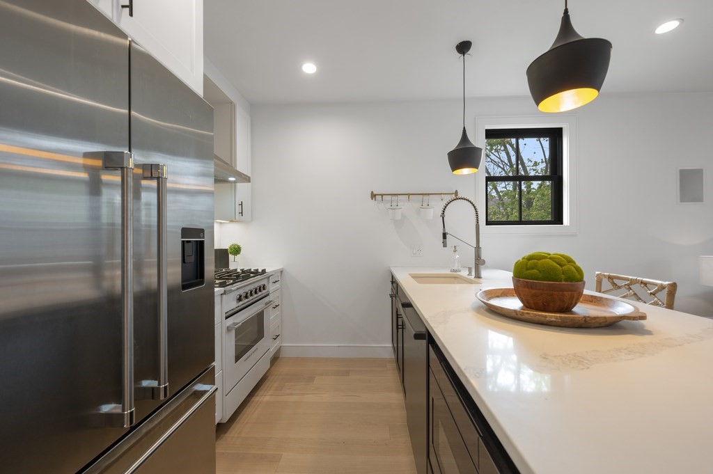 228 Webster Street, Unit 2 Boston, MA 02128 - Photo 13 of 32 a kitchen with a refrigerator and a sink