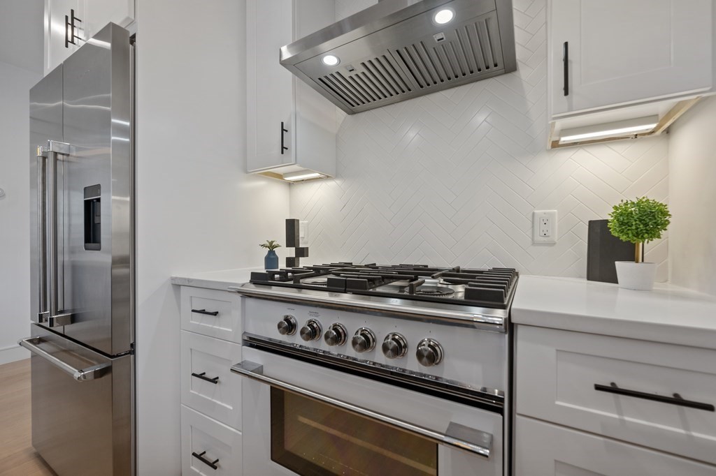 228 Webster Street, Unit 2 Boston, MA 02128 - Photo 15 of 32 a stove top oven sitting inside of a kitchen