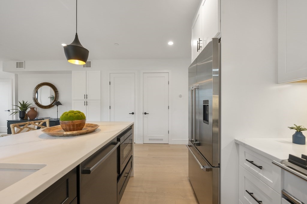 228 Webster Street, Unit 2 Boston, MA 02128 - Photo 16 of 32 a kitchen with a sink and a refrigerator