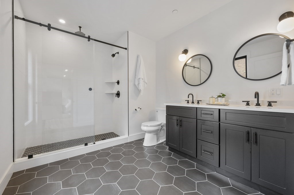 228 Webster Street, Unit 2 Boston, MA 02128 - Photo 20 of 32 a bathroom with a double vanity sink mirror and toilet