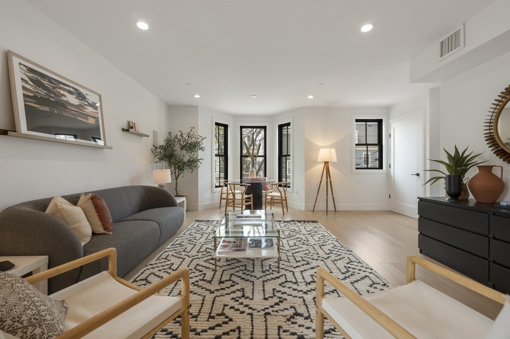 228 Webster Street, Unit 2 Boston, MA 02128 - Photo 2 of 32 a living room with furniture lamp and rug