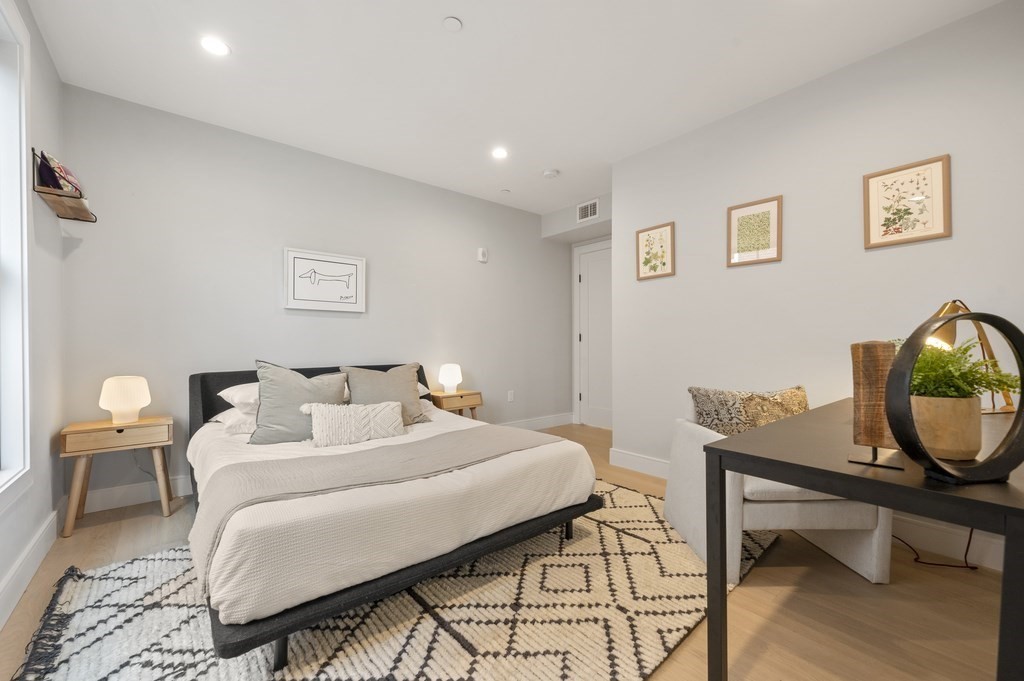 228 Webster Street, Unit 2 Boston, MA 02128 - Photo 22 of 32 a bedroom that has a bed and a chair in it