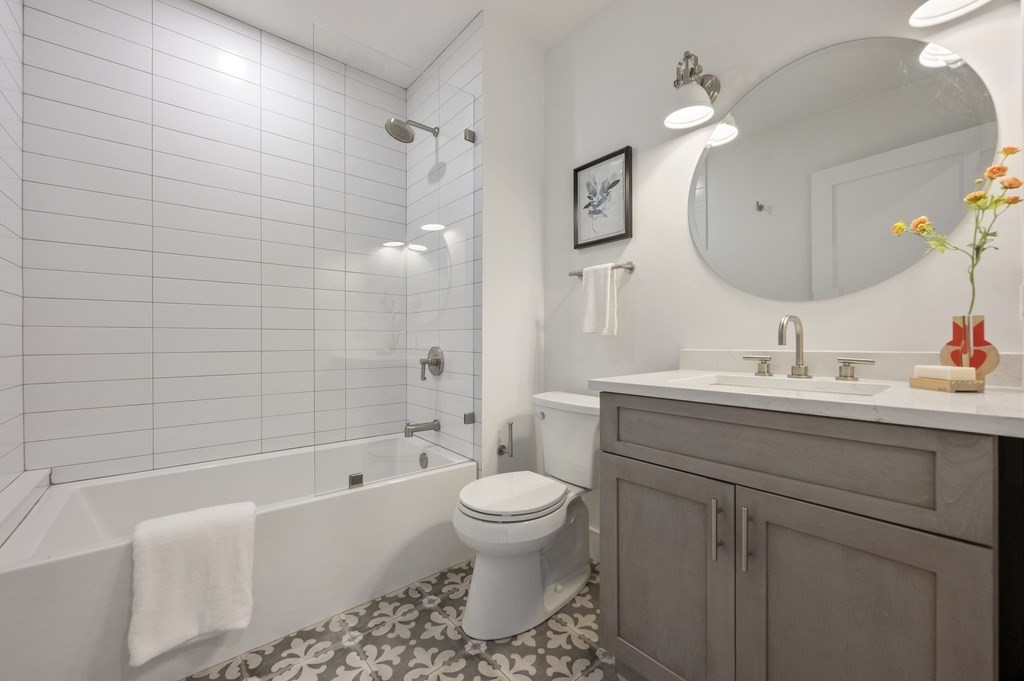 228 Webster Street, Unit 2 Boston, MA 02128 - Photo 24 of 32 a bathroom with a sink a toilet and a mirror