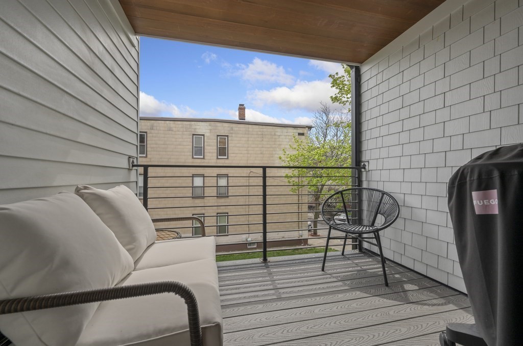 228 Webster Street, Unit 2 Boston, MA 02128 - Photo 26 of 32 a view of balcony with wooden floor and seating space