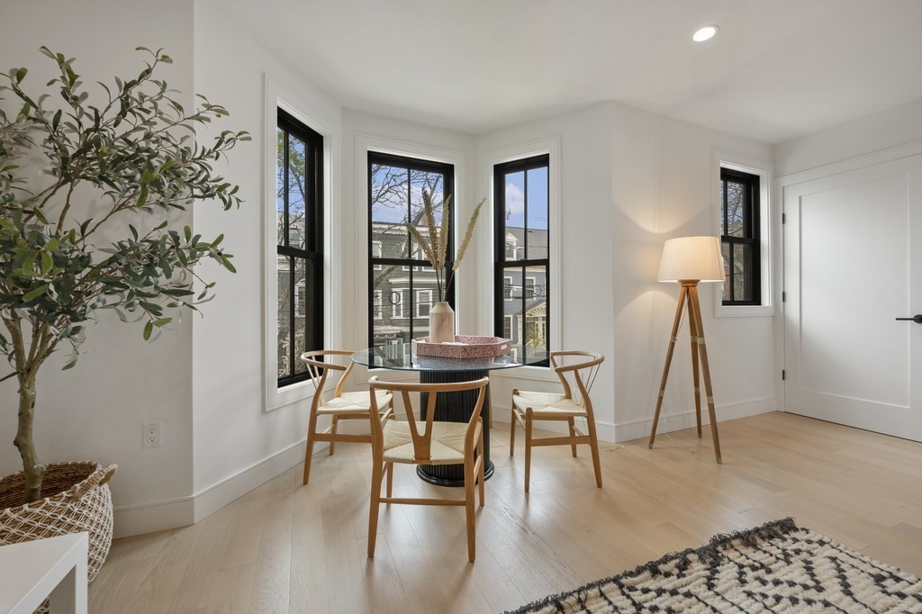 228 Webster Street, Unit 2 Boston, MA 02128 - Photo 6 of 32 a dining room with chandelier and wooden floor