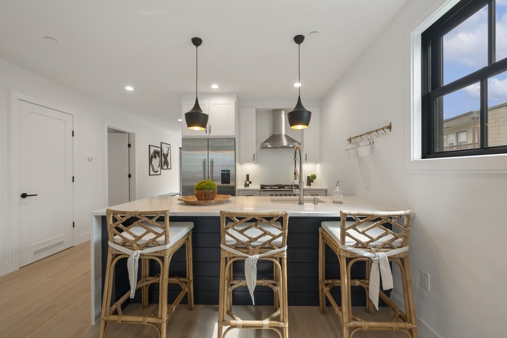 228 Webster Street, Unit 2 Boston, MA 02128 - Photo 10 of 32 a kitchen with a table and chairs in it
