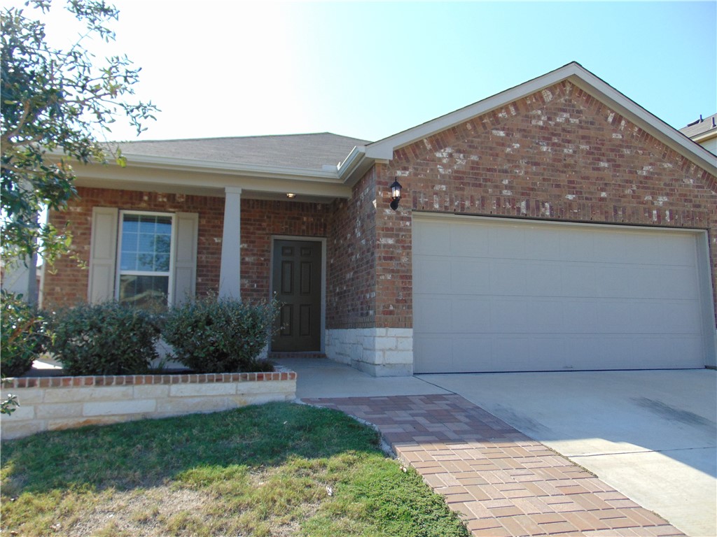 a view of a house with a yard and plants