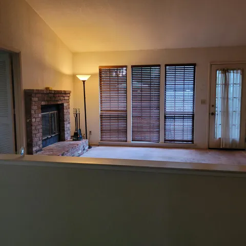 an empty room with furniture and a fireplace