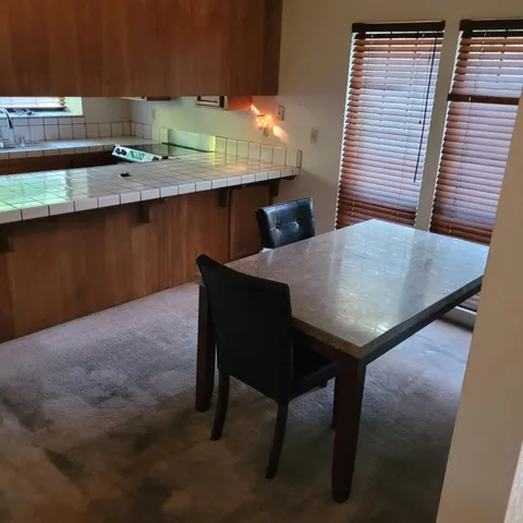 a backyard of a house with table and chairs