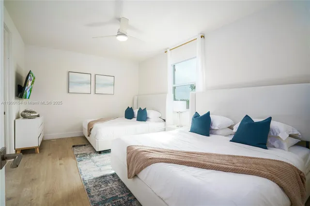 a view of a backyard with a garden and entertaining space