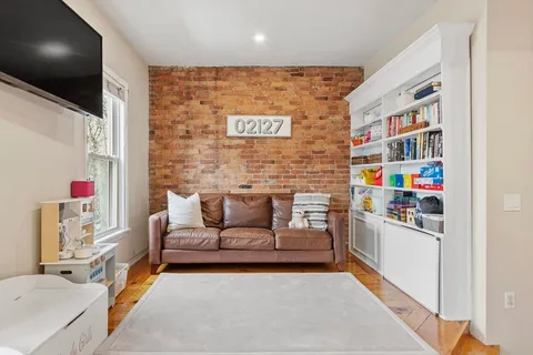 a living room with furniture and a book shelf
