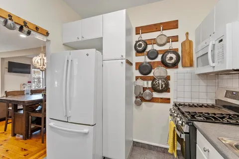 a kitchen with stainless steel appliances and a refrigerator