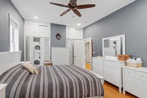 a bedroom with a bed and a chandelier