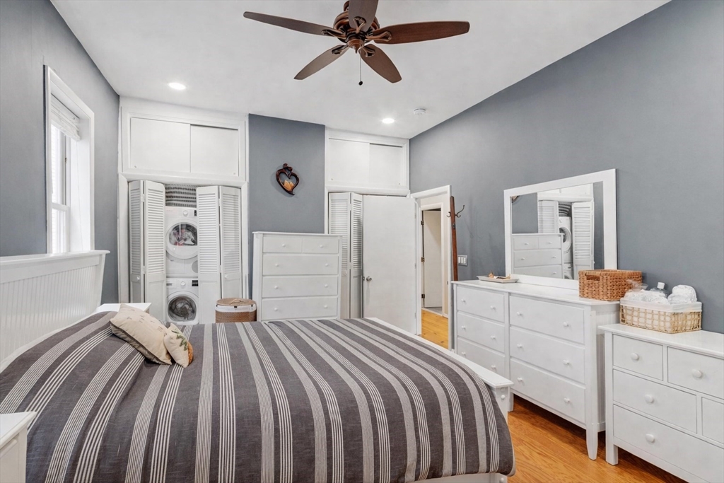 787 East 3rd Street, Unit 2 Boston, MA 02127 - Photo 9 of 15 a bedroom with a bed and a chandelier