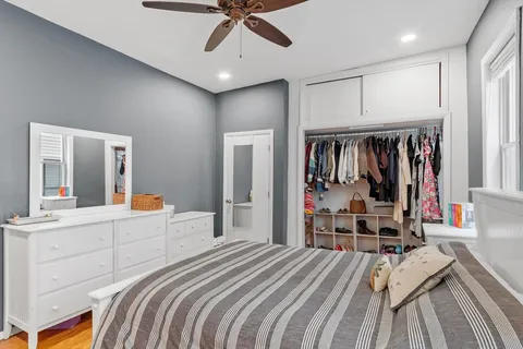 a bedroom with a bed and a large mirror