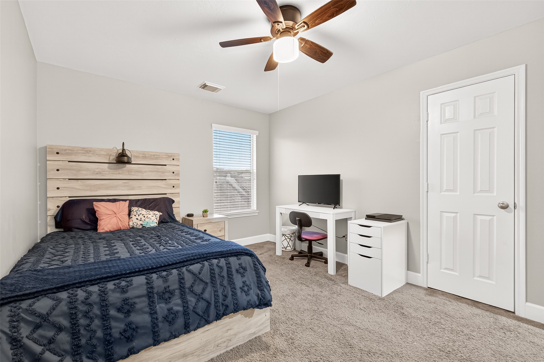 7415 Riven Oaks Court Cypress, TX 77433 - Photo 35 of 42 Spacious secondary bedroom featuring a ceiling fan, ample natural light, and a comfortable layout perfect for family or guests.