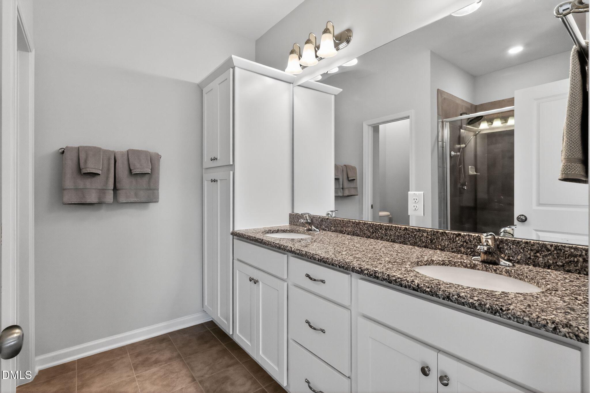 1118 Commack Drive Durham, NC 27703 - Photo 12 of 30 a bathroom with a granite countertop sink and a mirror