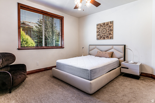 5326 North Oldgate Road Heber City, UT 84032 - Photo 15 of 32 Carpeted room featuring a large window with wood trim, crown molding, and a ceiling fan with integrated lighting
