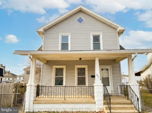 a view of a house with wooden fence