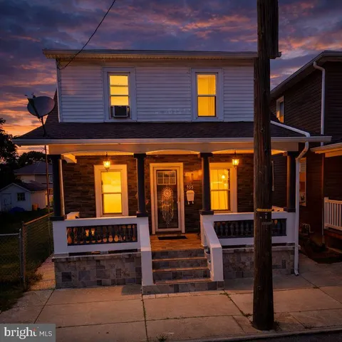 a view of front door of house with outdoor seating
