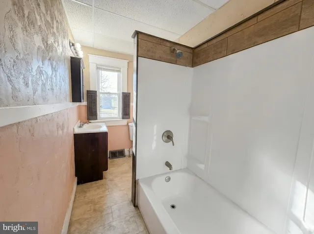 a bathroom with a bathtub and a sink