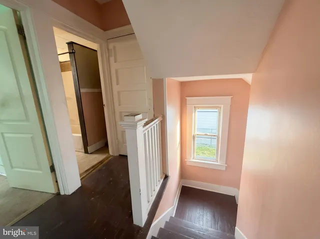 a view of an entryway door with a hallway