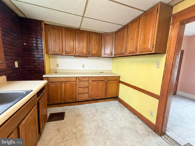a kitchen with a sink stove and cabinets