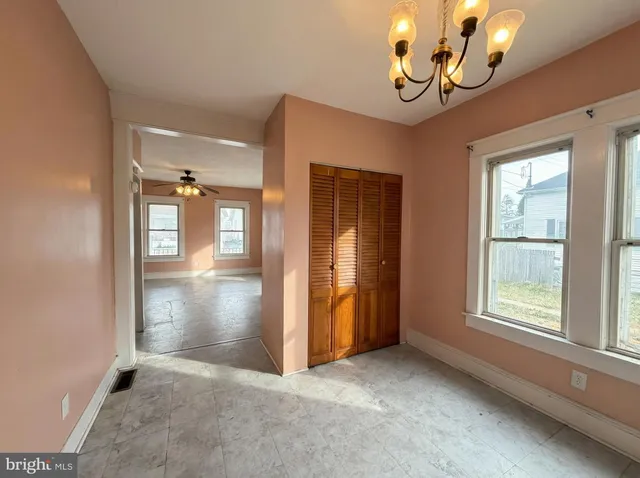 an empty room with windows and entrance