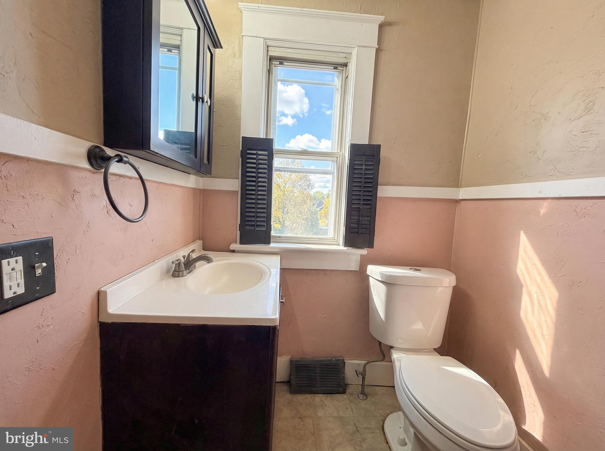 931 East Princess Street York, PA 17403 - Photo 6 of 15 a bathroom with a toilet sink and mirror