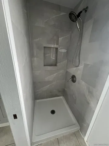 a bathroom with a glass shower door
