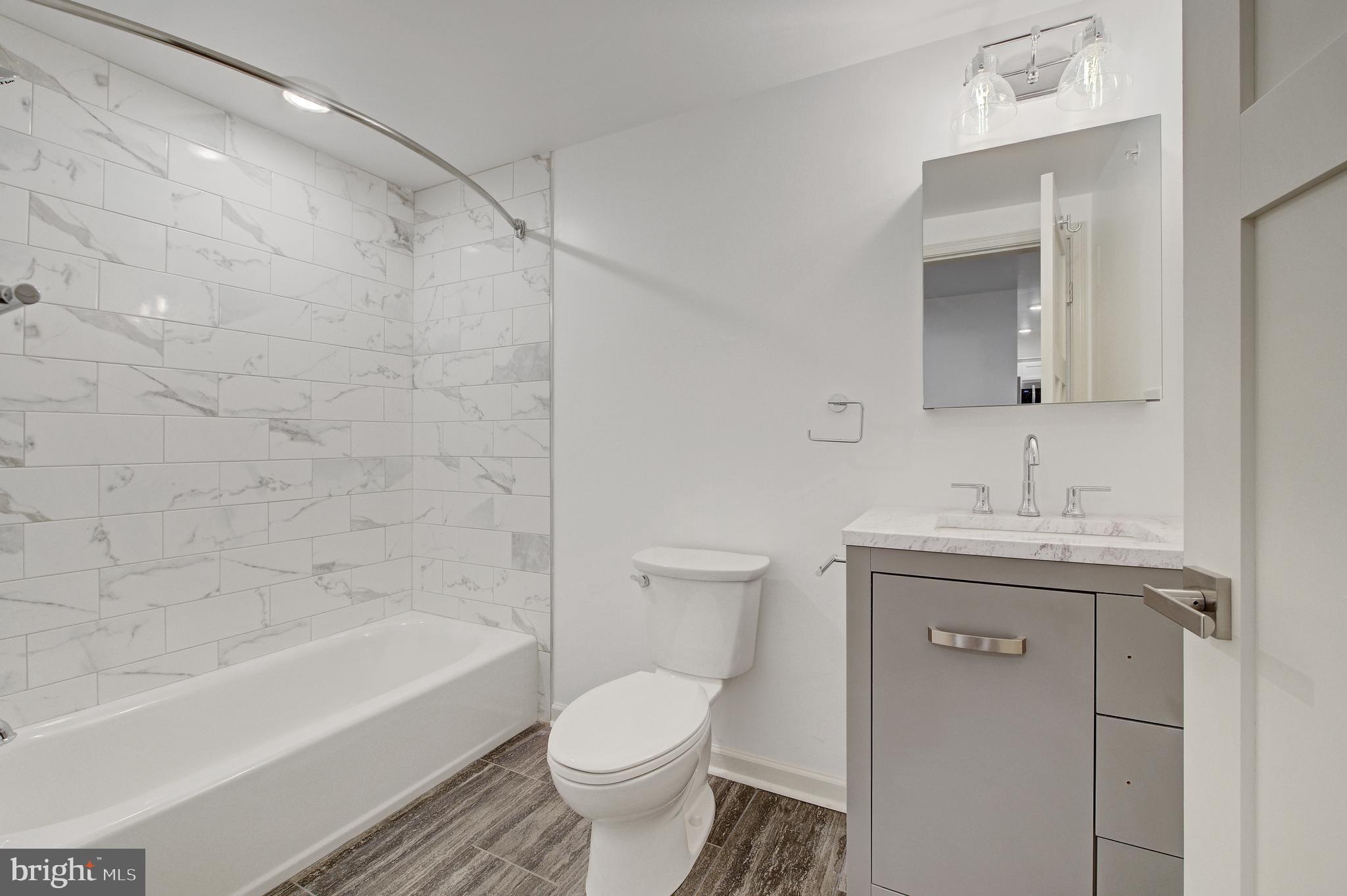 6649 Ridge Avenue, Unit C207 Philadelphia, PA 19128 - Photo 7 of 10 a bathroom with a sink toilet and shower