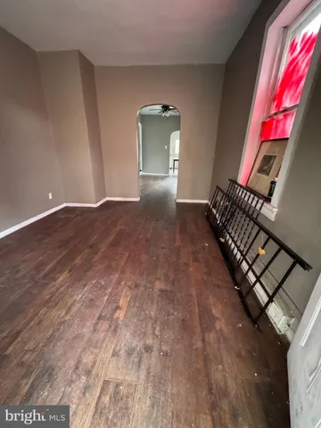 a view of an empty room and wooden floor