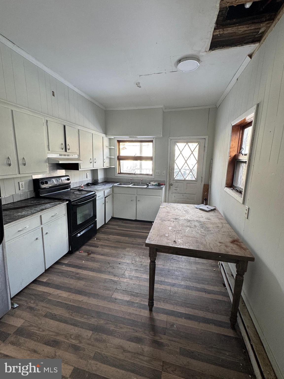 401 Walnut Street Ashland, PA 17921 - Photo 4 of 8 a kitchen with cabinets wooden floor and stainless steel appliances