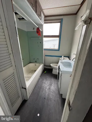 a bathroom with a sink toilet and tub