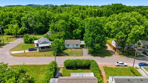 an aerial view of a house with garden space and street view