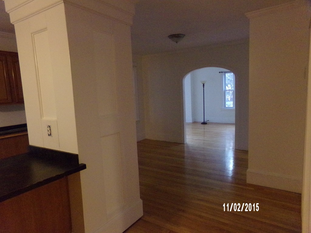 7 Dellwood Road Worcester, MA 01602 - Photo 18 of 19 an empty room with wooden floor and cabinet