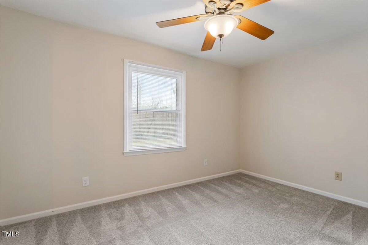 5144 Shield Circle Raleigh, NC 27603 - Photo 21 of 41 an empty room with a window and a fan