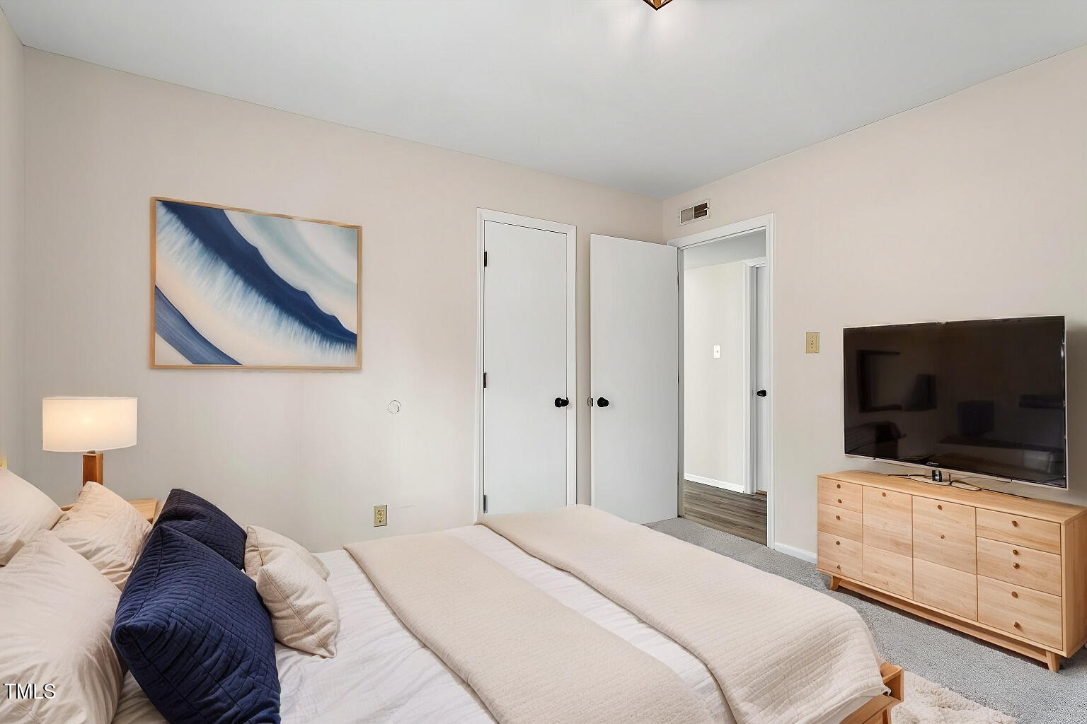 5144 Shield Circle Raleigh, NC 27603 - Photo 29 of 41 a bedroom with a bed and a flat screen tv