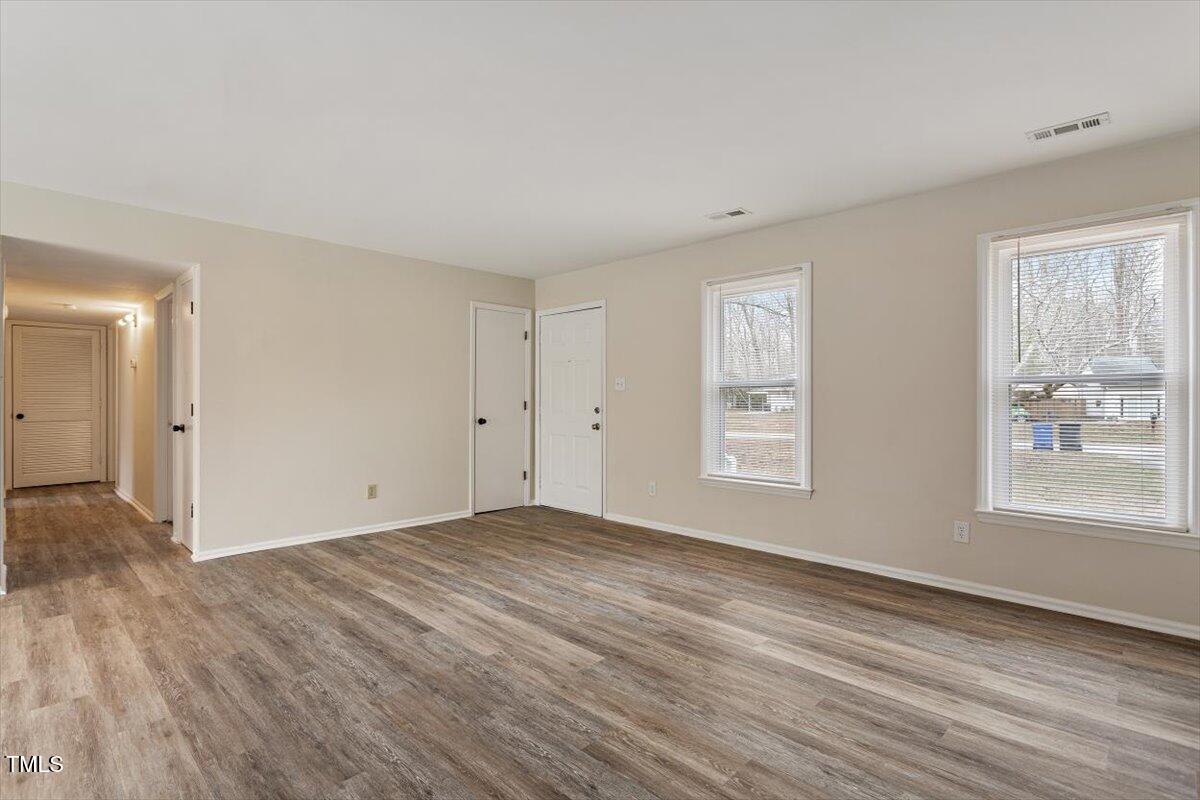 5144 Shield Circle Raleigh, NC 27603 - Photo 9 of 41 a view of an empty room with wooden floor and a window