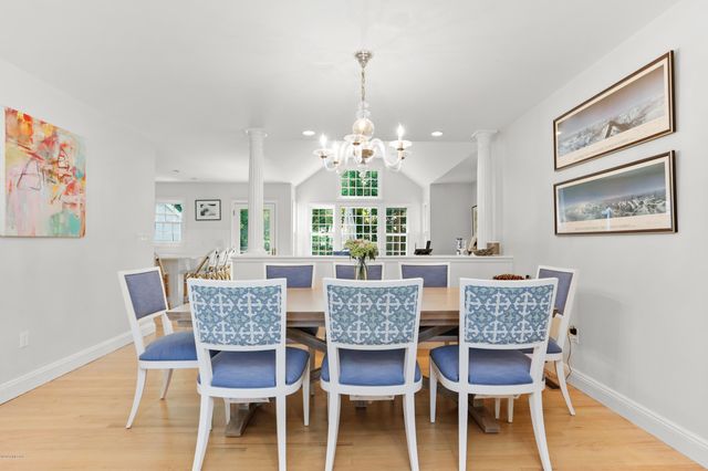 a dining room with furniture a rug and a chandelier