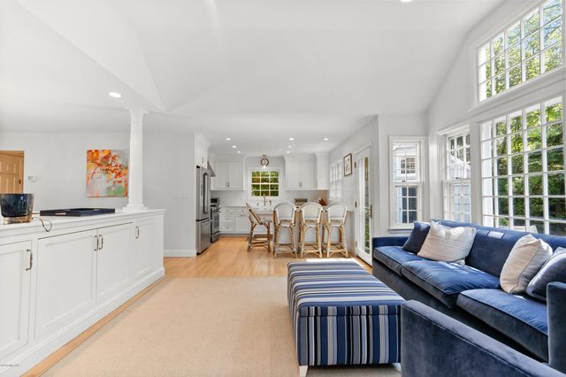 a living room with furniture a fireplace and a large window